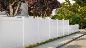 White Vinyl Fence Salem County NJ Solid white vinyl fence next to sidewalk